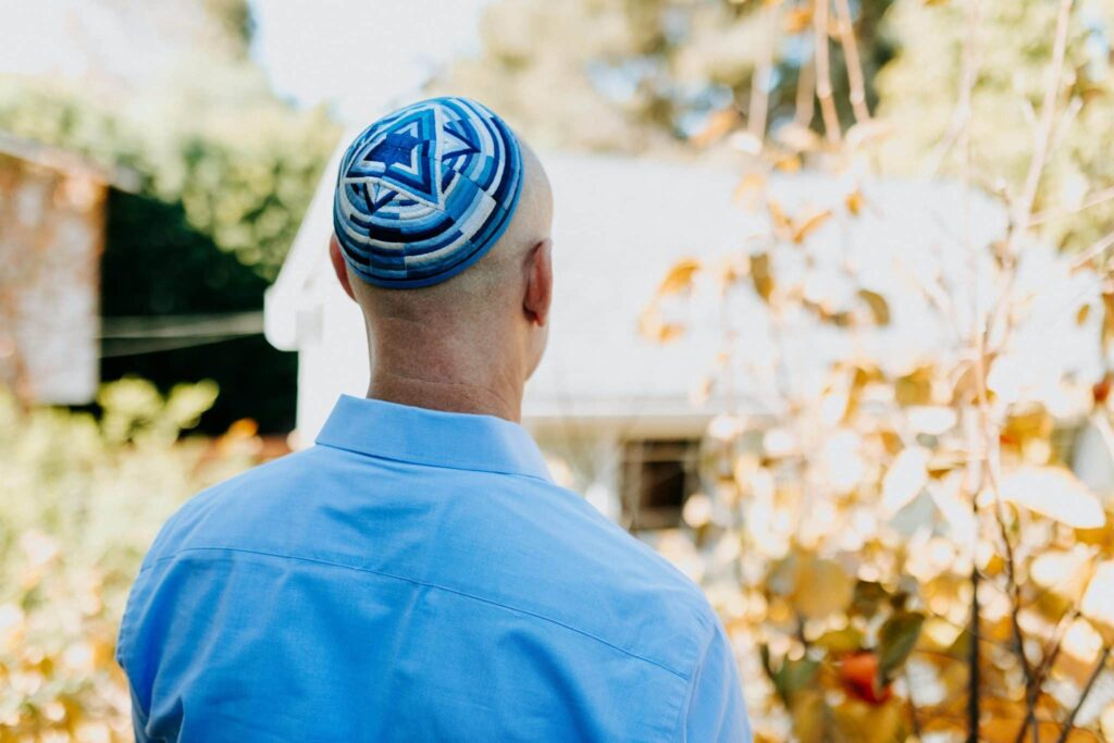 A 70-year-old man wearing a kippah thrown to the ground and beaten.